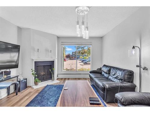 9101-315, Southampton Drive Sw, Calgary, AB - Indoor Photo Showing Living Room With Fireplace