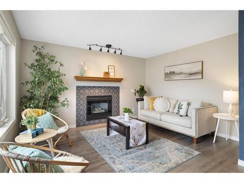 71 Tipping Close Se, Airdrie, AB - Indoor Photo Showing Living Room With Fireplace