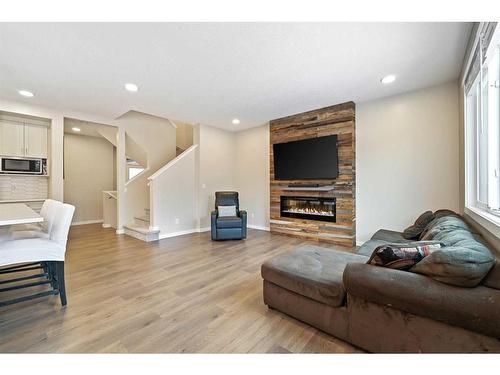 618 Kingsmere Way Se, Airdrie, AB - Indoor Photo Showing Living Room With Fireplace