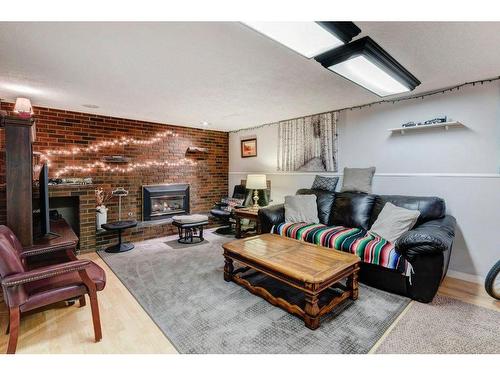 635 Marian Crescent Ne, Calgary, AB - Indoor Photo Showing Living Room With Fireplace