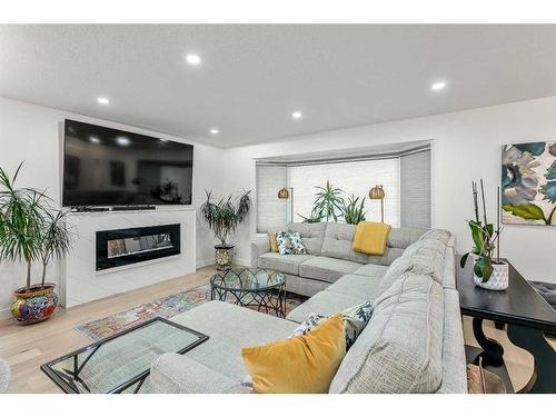 103 Woodpark Place Sw, Calgary, AB - Indoor Photo Showing Living Room With Fireplace