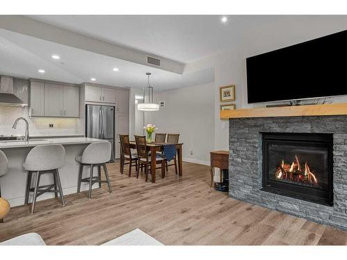 109-707 Spring Creek Drive, Canmore, AB - Indoor Photo Showing Living Room With Fireplace