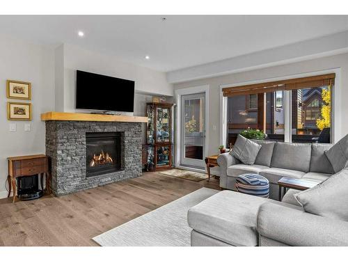 109-707 Spring Creek Drive, Canmore, AB - Indoor Photo Showing Living Room With Fireplace