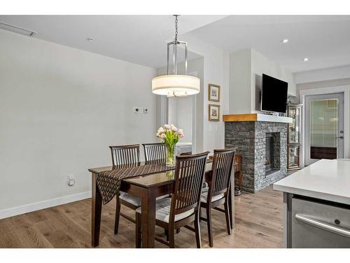 109-707 Spring Creek Drive, Canmore, AB - Indoor Photo Showing Dining Room With Fireplace