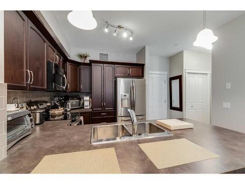 3107-4 Kingsland Close Se, Airdrie, AB - Indoor Photo Showing Kitchen With Double Sink