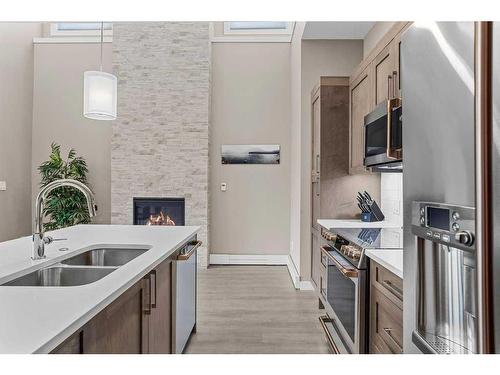 115-106 Stewart Creek Rise, Canmore, AB - Indoor Photo Showing Kitchen With Double Sink With Upgraded Kitchen