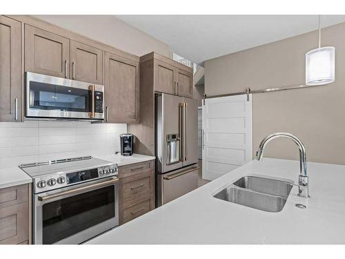 115-106 Stewart Creek Rise, Canmore, AB - Indoor Photo Showing Kitchen With Double Sink With Upgraded Kitchen