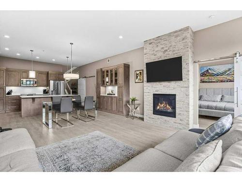 115-106 Stewart Creek Rise, Canmore, AB - Indoor Photo Showing Living Room With Fireplace