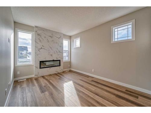 151 Amblefield Avenue Nw, Calgary, AB - Indoor Photo Showing Living Room With Fireplace