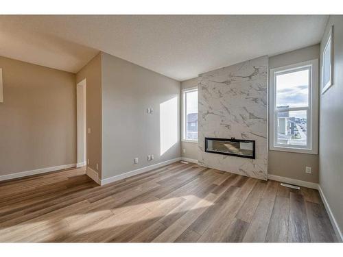 151 Amblefield Avenue Nw, Calgary, AB - Indoor Photo Showing Living Room With Fireplace