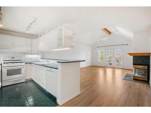 2002 Patterson View Sw, Calgary, AB - Indoor Photo Showing Kitchen With Fireplace