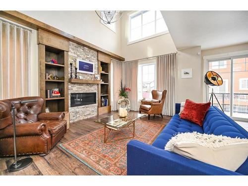 201 Kinniburgh Cove, Chestermere, AB - Indoor Photo Showing Living Room With Fireplace