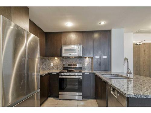 1107-99 Spruce Place Sw, Calgary, AB - Indoor Photo Showing Kitchen With Stainless Steel Kitchen With Double Sink With Upgraded Kitchen