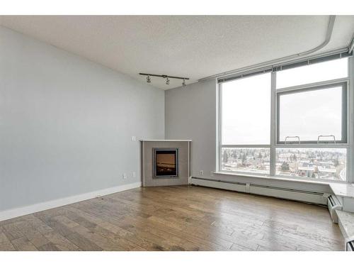 1107-99 Spruce Place Sw, Calgary, AB - Indoor Photo Showing Other Room With Fireplace