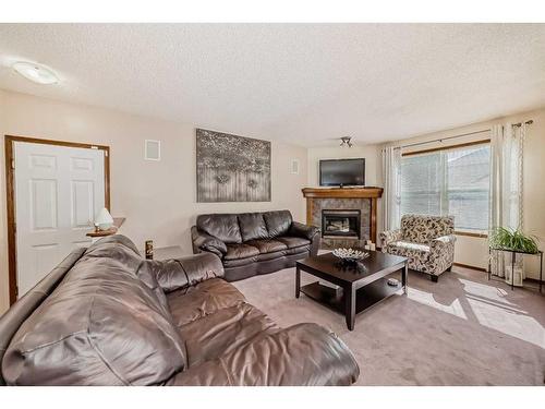 15225 Prestwick Boulevard Se, Calgary, AB - Indoor Photo Showing Living Room With Fireplace