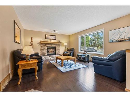 266 Rocky Ridge Bay Nw, Calgary, AB - Indoor Photo Showing Living Room With Fireplace