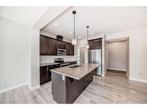 298 Kingfisher Crescent Se, Airdrie, AB - Indoor Photo Showing Kitchen With Stainless Steel Kitchen With Double Sink With Upgraded Kitchen