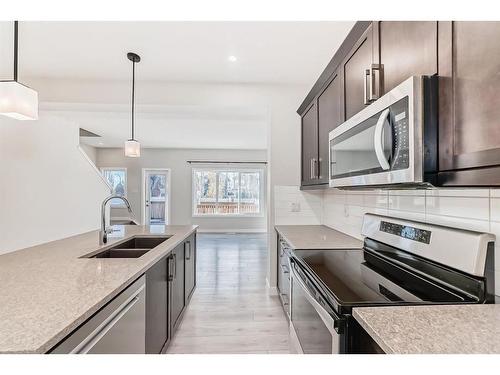 298 Kingfisher Crescent Se, Airdrie, AB - Indoor Photo Showing Kitchen With Stainless Steel Kitchen With Double Sink With Upgraded Kitchen