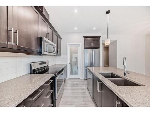 298 Kingfisher Crescent Se, Airdrie, AB - Indoor Photo Showing Kitchen With Stainless Steel Kitchen With Double Sink With Upgraded Kitchen