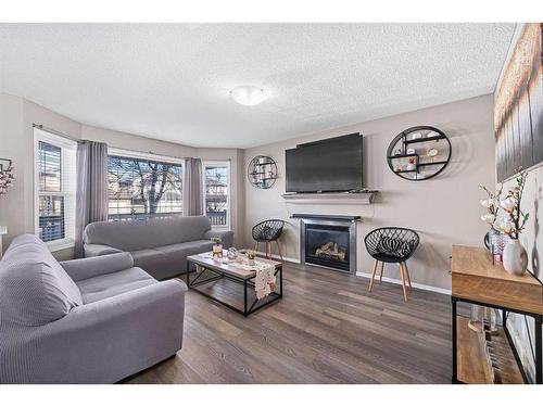 245 Evermeadow Avenue Sw, Calgary, AB - Indoor Photo Showing Living Room With Fireplace