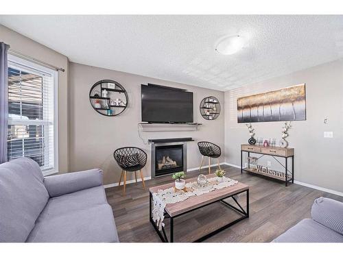 245 Evermeadow Avenue Sw, Calgary, AB - Indoor Photo Showing Living Room With Fireplace