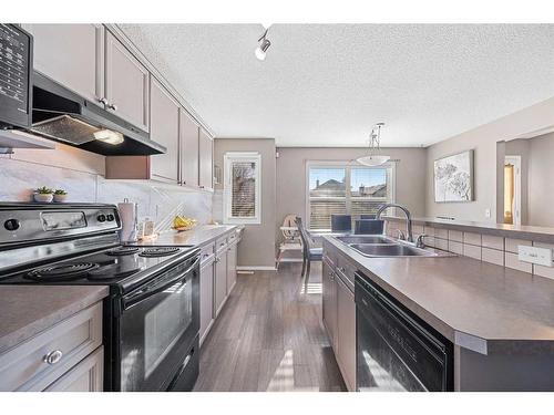 245 Evermeadow Avenue Sw, Calgary, AB - Indoor Photo Showing Kitchen With Double Sink