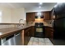 4204-115 Prestwick Villas Se, Calgary, AB  - Indoor Photo Showing Kitchen With Double Sink 