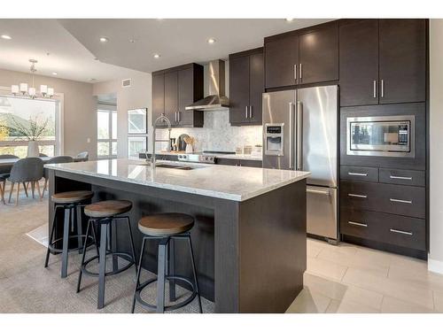 204-145 Burma Star Road Sw, Calgary, AB - Indoor Photo Showing Kitchen With Stainless Steel Kitchen With Upgraded Kitchen