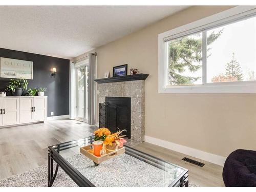 105-200 Shawnessy Drive Sw, Calgary, AB - Indoor Photo Showing Living Room With Fireplace