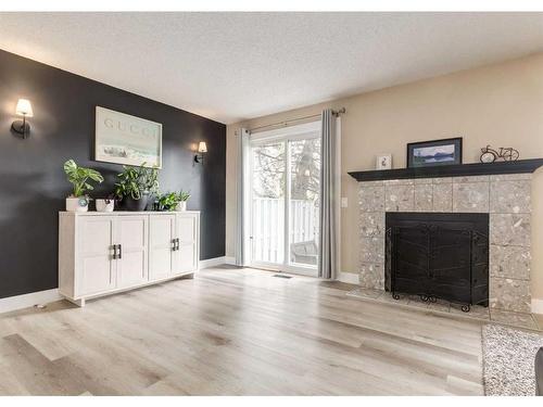 105-200 Shawnessy Drive Sw, Calgary, AB - Indoor Photo Showing Living Room With Fireplace