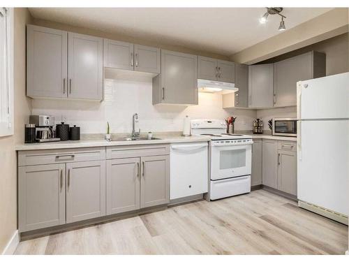 105-200 Shawnessy Drive Sw, Calgary, AB - Indoor Photo Showing Kitchen With Double Sink