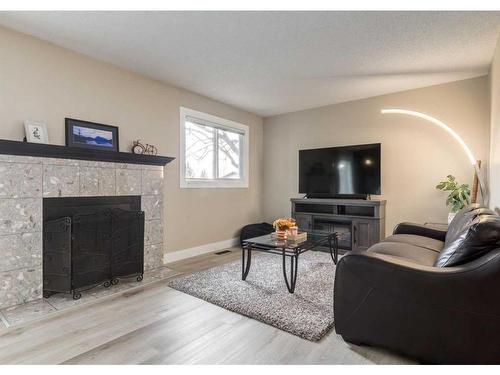 105-200 Shawnessy Drive Sw, Calgary, AB - Indoor Photo Showing Living Room With Fireplace