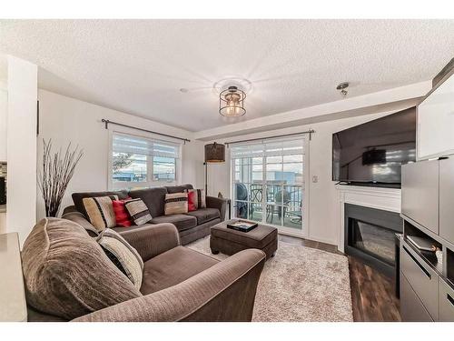 3206-279 Copperpond Common Se, Calgary, AB - Indoor Photo Showing Living Room With Fireplace