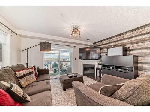 3206-279 Copperpond Common Se, Calgary, AB - Indoor Photo Showing Living Room With Fireplace