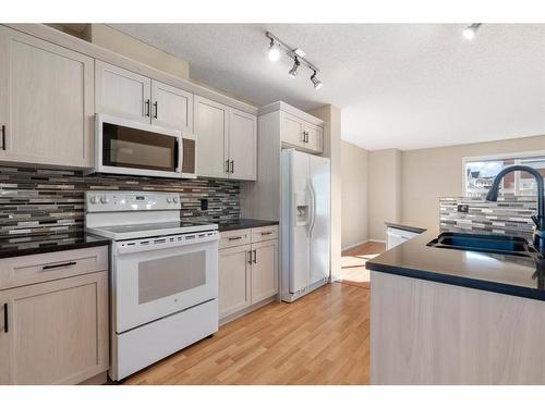 124 Promenade Way Se, Calgary, AB - Indoor Photo Showing Kitchen With Double Sink