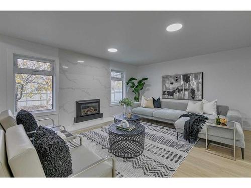 35 Mckinley Road Se, Calgary, AB - Indoor Photo Showing Living Room With Fireplace