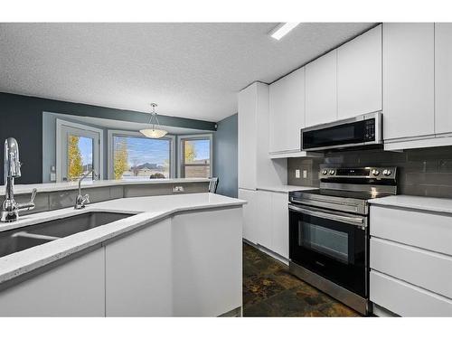 16 Everwoods Road Sw, Calgary, AB - Indoor Photo Showing Kitchen With Double Sink