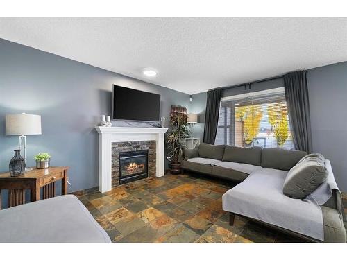 16 Everwoods Road Sw, Calgary, AB - Indoor Photo Showing Living Room With Fireplace