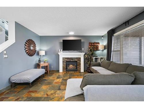 16 Everwoods Road Sw, Calgary, AB - Indoor Photo Showing Living Room With Fireplace