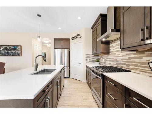 85 Fireside Circle, Cochrane, AB - Indoor Photo Showing Kitchen With Stainless Steel Kitchen With Double Sink With Upgraded Kitchen