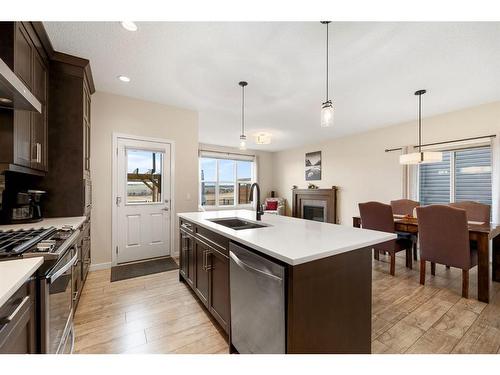 85 Fireside Circle, Cochrane, AB - Indoor Photo Showing Kitchen With Double Sink With Upgraded Kitchen