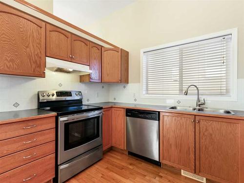 99 Eversyde Circle Sw, Calgary, AB - Indoor Photo Showing Kitchen With Double Sink