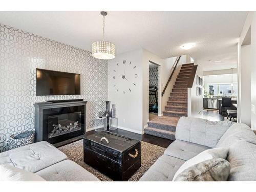 41 Copperpond Avenue Se, Calgary, AB - Indoor Photo Showing Living Room With Fireplace