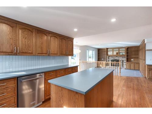 523 Woodbriar Place Sw, Calgary, AB - Indoor Photo Showing Kitchen With Fireplace