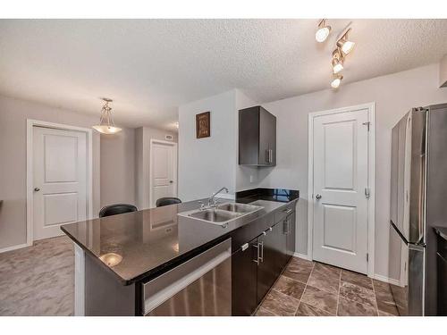 319-195 Kincora Glen Road Nw, Calgary, AB - Indoor Photo Showing Kitchen With Double Sink