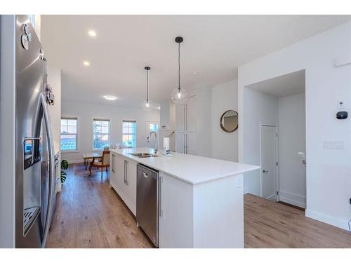 843 Carrington Boulevard Nw, Calgary, AB - Indoor Photo Showing Kitchen With Double Sink With Upgraded Kitchen