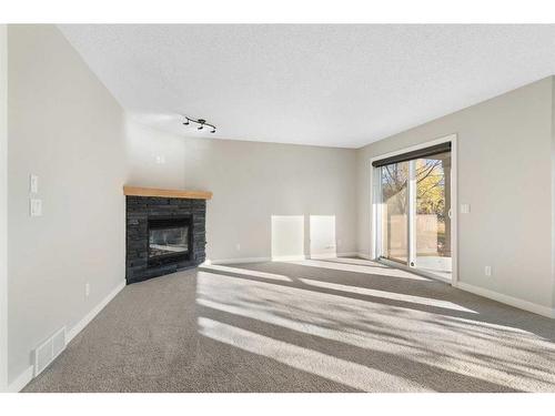 8 Sunset Close, Cochrane, AB - Indoor Photo Showing Other Room With Fireplace