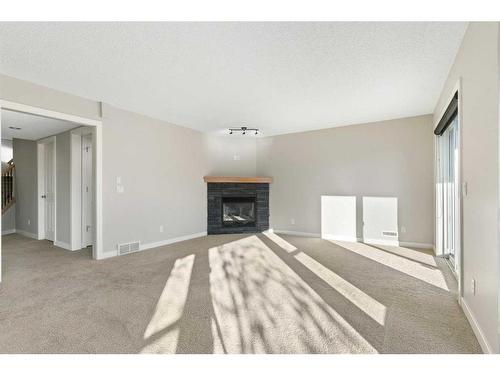 8 Sunset Close, Cochrane, AB - Indoor With Fireplace