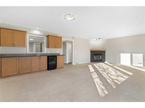 8 Sunset Close, Cochrane, AB - Indoor With Fireplace