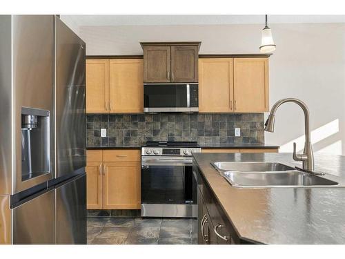 8 Sunset Close, Cochrane, AB - Indoor Photo Showing Kitchen With Double Sink